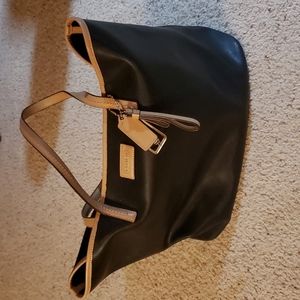Coach leather bag/tote black with tan trim and carry straps.
